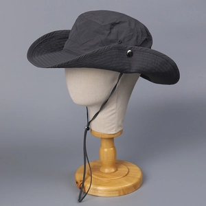 Detail of dark grey sun hat featuring adjustable wind cord and breathable side vents