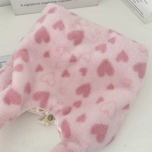 Close-up of soft pink plush tote bag with heart patterns and sturdy white zipper detail