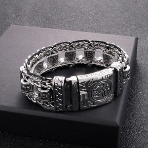 Detail of vintage silver titanium steel bracelet with carved scriptures on black gift box