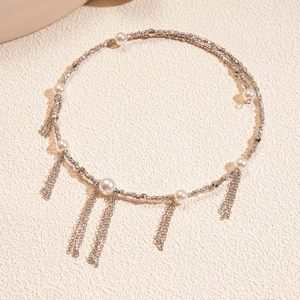 Detailed shot of silver twisted rope necklace with pearls and metallic fringe tassels
