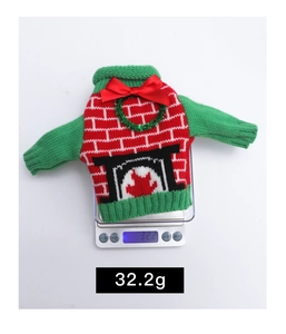Detailed view of 32.2g Christmas knit wine bottle cover with festive fireplace pattern