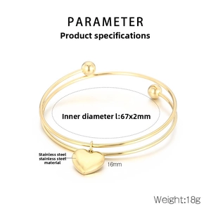 Detailed view of golden double-layer stainless steel bangle with a heart pendant and dimensions