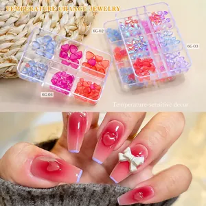 Detailed view of temperature color-changing nail art charms in a multi-grid storage box