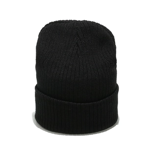 Macro detail of high-elastic black ribbed knit fabric texture on a winter beanie hat