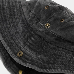 Close-up of vintage washed cotton bucket hat with metal eyelets and reinforced stitching