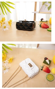Close-up of mini quilted jelly bag featuring gold twist lock and fine chain strap