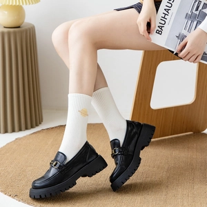 Classic black loafers with gold horsebit buckle and white planet embroidered socks