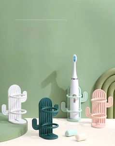 Macro detail of cactus-shaped wall-mounted toothbrush holders with drainage design