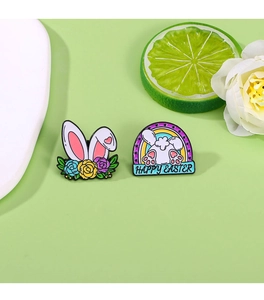 Detail of Easter bunny enamel pins with rabbit ears, rainbow design, and floral elements