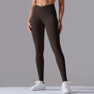 Detail of high-waist yoga leggings featuring a seamless cross V-waistband in dark brown