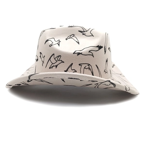 Detail of cream Western cowboy hat featuring black seagull patterns and curved brim