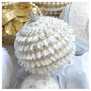 Detailed macro view of white textured Christmas ball ornament with golden thread accents