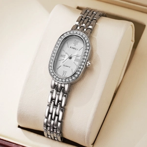 Macro detail of silver quartz watch with diamond bezel on elegant display pillow