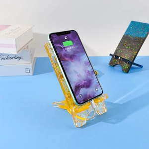 DIY resin phone stand with gold foil showing charging cable cutout and desktop utility