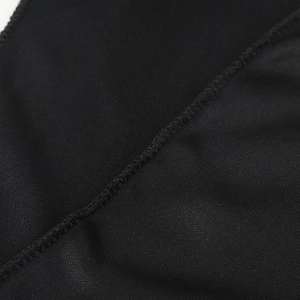Close-up of black breathable mesh fabric with reinforced overlock stitching detail