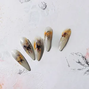 Macro view of artisan ink butterfly nail art stickers with hand-painted gel details