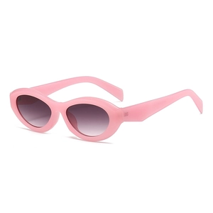 Pink oval frame sunglasses with gradient purple lenses in a vintage Y2K aesthetic