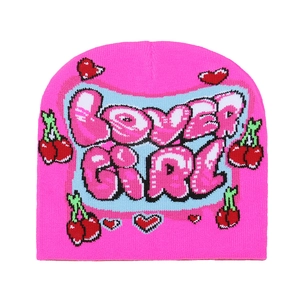 Detail of pink knitted beanie featuring LOVER GIRL lettering and cherry embroidery