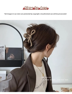 Detail of coffee brown bow hair claw clip with matte texture on model's hairstyle