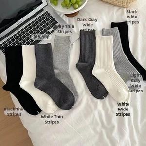 Macro shot of cotton sports socks in black and grey tones with ribbed texture detail