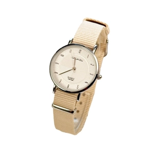 Minimalist women's quartz watch with a beige nylon strap and silver metal case on white background