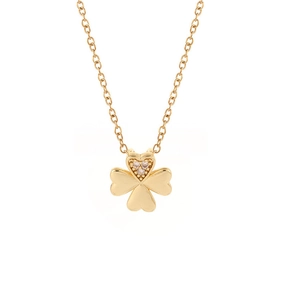 Close-up of golden four-leaf clover pendant with heart petals and sparkling crystals