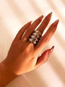 Macro shot of silver ribbed chunky dome ring with a mirror polished metal finish
