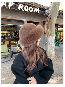 Detailed close-up of thick brown faux fur plush bucket hat for winter warmth