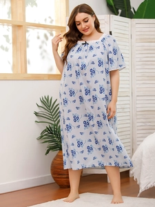 Detail of square neckline with white lace trim and small black bow on floral sleepwear