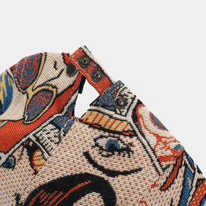 Detail of colorful butterfly jacquard fabric and metal snap buttons on retro beret hat