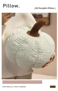 Detailed view of model holding a plush floral pumpkin pillow with soft cotton texture