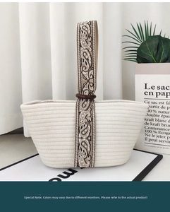 Detail of woven handbag with ethnic jacquard strap and dark brown wooden ring connector