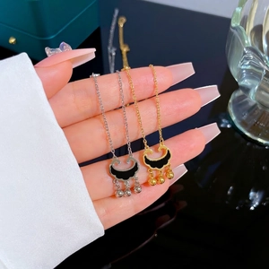 Titanium steel concentric lock necklace in gold and silver with bell tassels