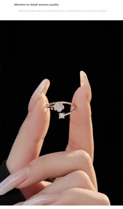 Macro view of silver camellia ring with white petal flower and sparkling cubic zirconia