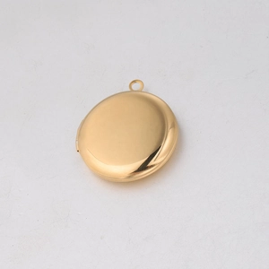 Detailed view of a round 316L stainless steel gold locket with a polished mirror finish