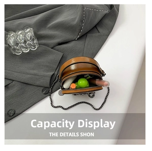 Top view of brown leather round mini crossbody bag showing interior storage capacity