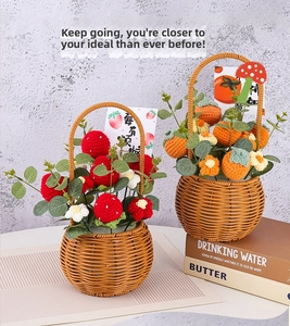 Detail of handmade crochet fruit baskets featuring strawberry and persimmon designs