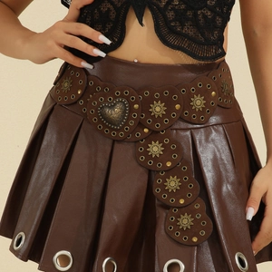 Vintage western brown leather belt with heart studs and rivets over a pleated skirt