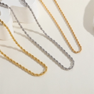 Chic gold and silver plated twist rope chains displayed on geometric props with soft shadows