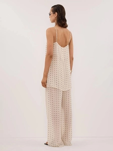 Detailed back view of a polka dot two-piece pajama set with spaghetti straps and wide-leg pants
