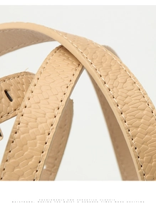 Close-up of beige faux snakeskin leather belt showing fine texture and stitching