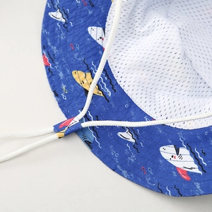 Detail of blue shark print sun hat showing white mesh lining and adjustable chin strap