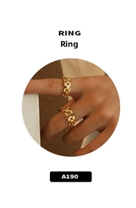 Detail shot of dual gold-plated textured chain rings worn on a hand, minimalist style