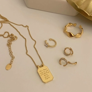 Detailed set of gold-plated jewelry with letter pendant necklace and zircon earrings