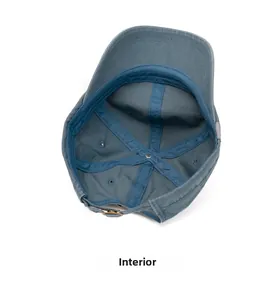Detailed interior of a dark blue cotton baseball cap with sweatband and bronze buckle