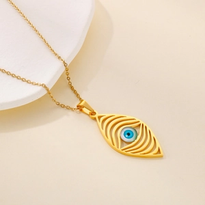 Detail of bohemian gold hollow eye necklace with blue resin evil eye charm on O-chain