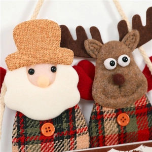 Detailed view of handmade fabric Christmas ornaments featuring Santa Claus and a reindeer