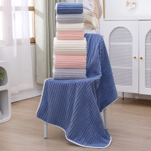 Three-piece coral fleece towel set with candy stripes in blue, pink, and grey colors