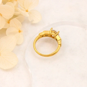 Macro detail of 18K gold plated ring with round zircon inlay and minimalist vintage design