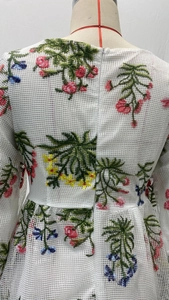 Detail der Blumenstickerei und verdecktem Reißverschluss am Netzkleid-Rücken